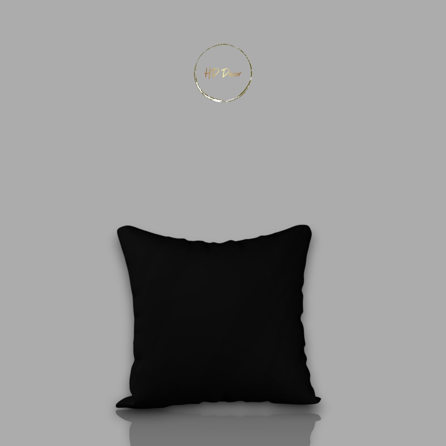 Black pillow on a gray background with a brand logo in the corner.